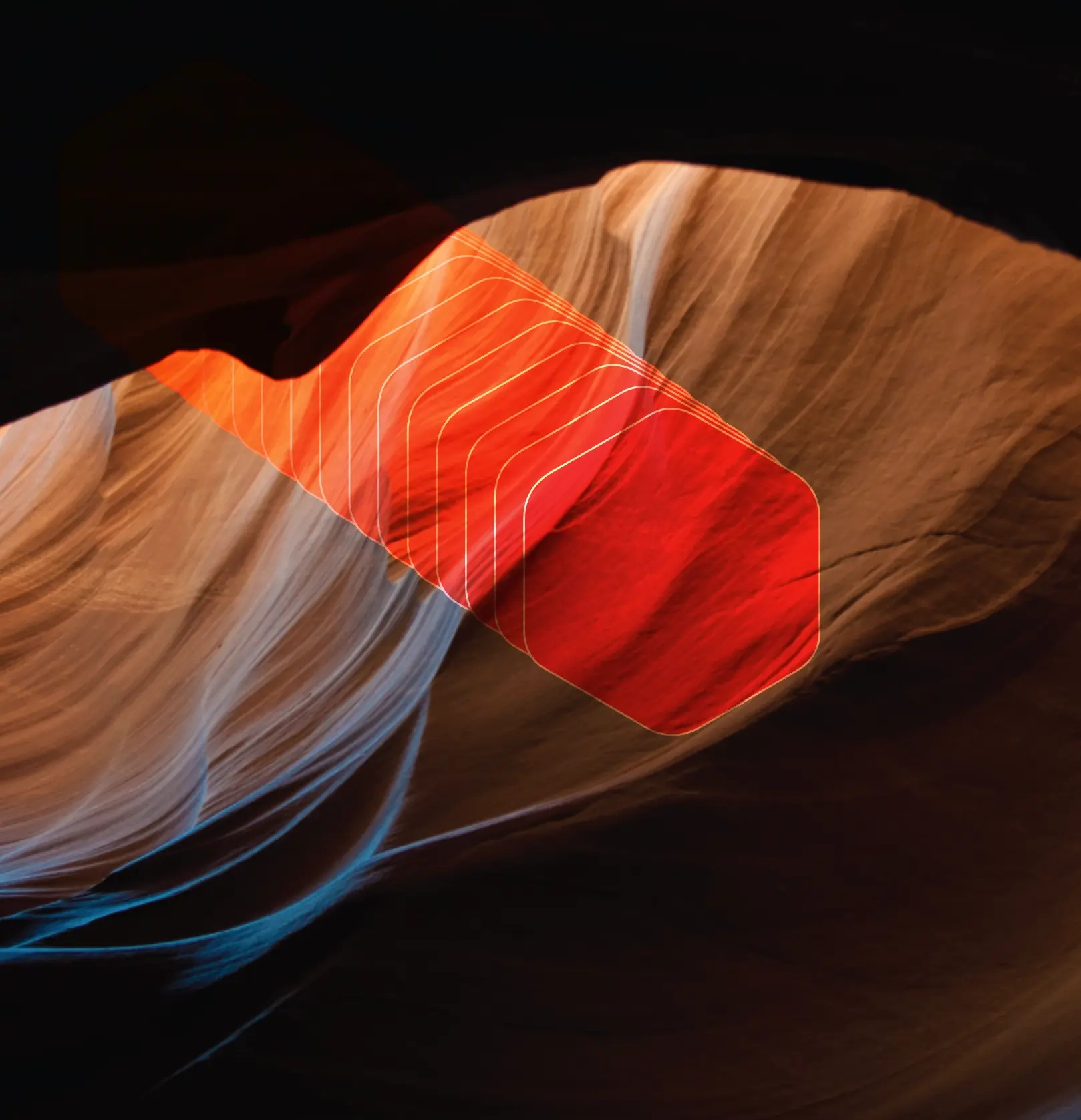 A vibrant red and blue light illuminates a picturesque canyon, creating a captivating contrast.