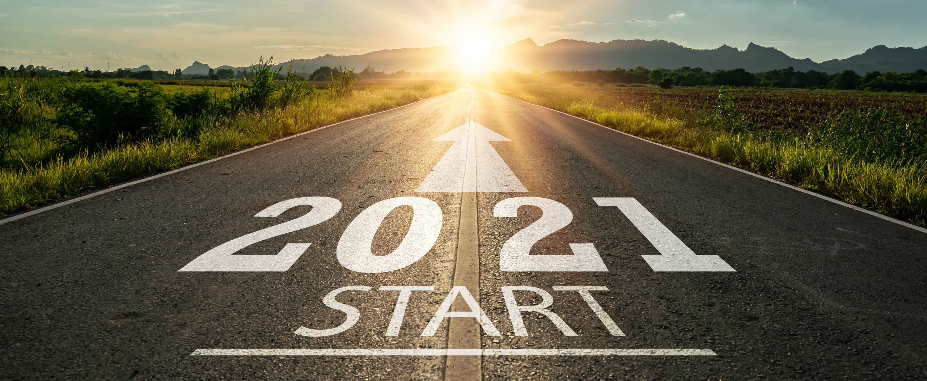2021 Start: An empty road with the words "2021 start" written on it, symbolizing the beginning of a new year and new opportunities.